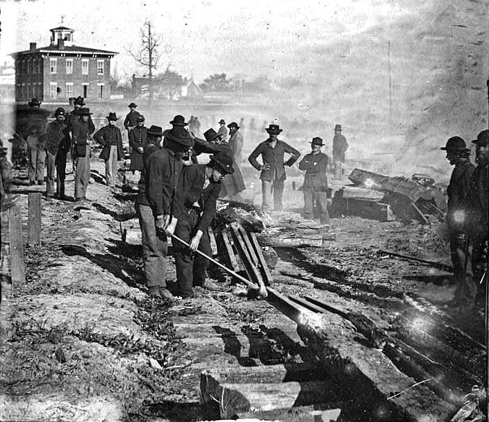 Sherman’s men tear up railroad track in Atlanta after capturing the city.  