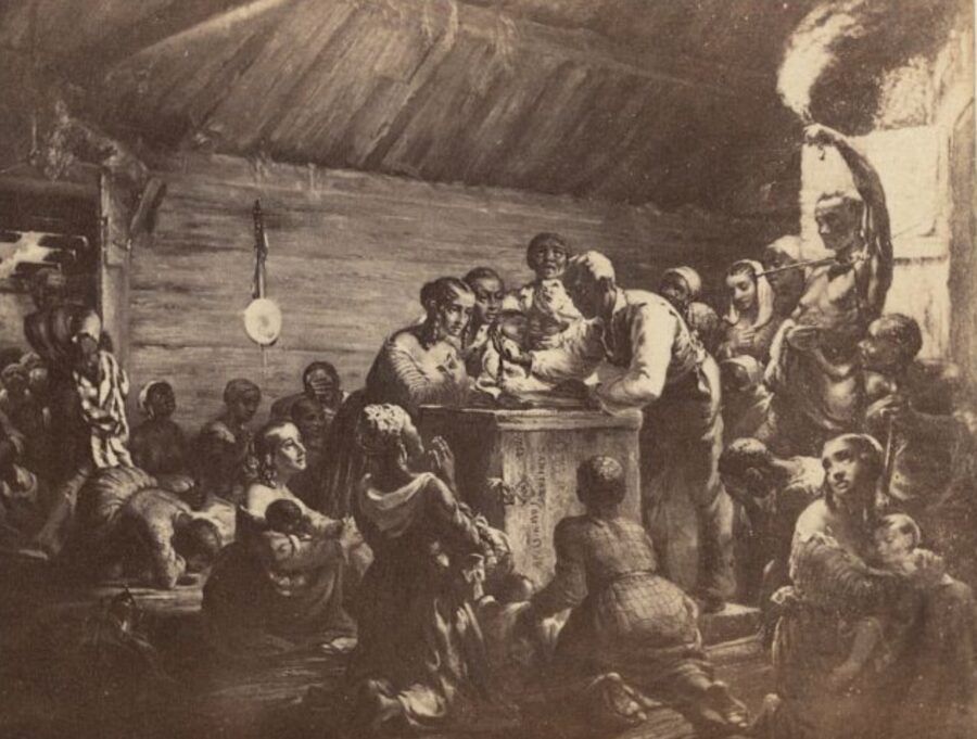 Enslaved men, women, and children gather around a man with a watch on the evening of December 31, 1862, as they wait for the Emancipation Proclamation to take effect.