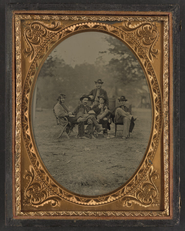 Unidentified Union officers sit outdoors with food on their laps in this undated wartime image.