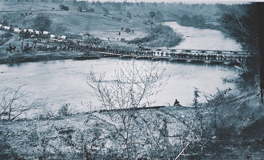 On May 4, 1864, the grand campaign began. Grant aimed to force Lee to abandon his strong Rapidan River defenses by crossing the river beyond the Confederate right flank. Grant’s hope was to then fight Lee on open ground. Photographer Timothy O’Sullivan was there to capture soldiers, beasts, and all the trappings of war as they crossed the Rapidan on two pontoon bridges at Germanna Ford. The blurred motion shows a mass of men from the Army of the Potomac, either the V or VI Corps, about to experience a whole new level of warfare.