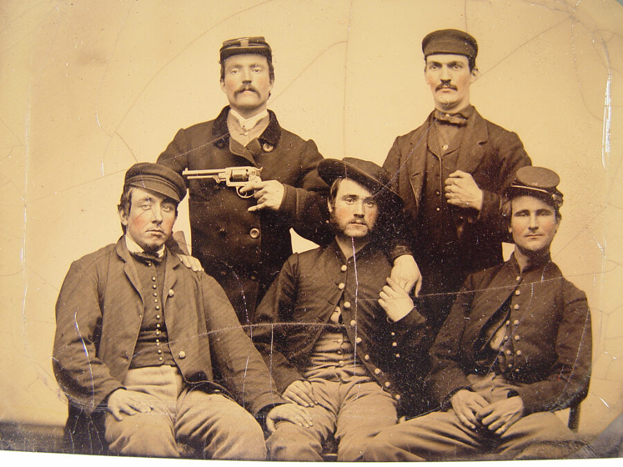 Three unidentified men in Union uniforms and two unidentified men, one pointing a Starr revolver at another's head