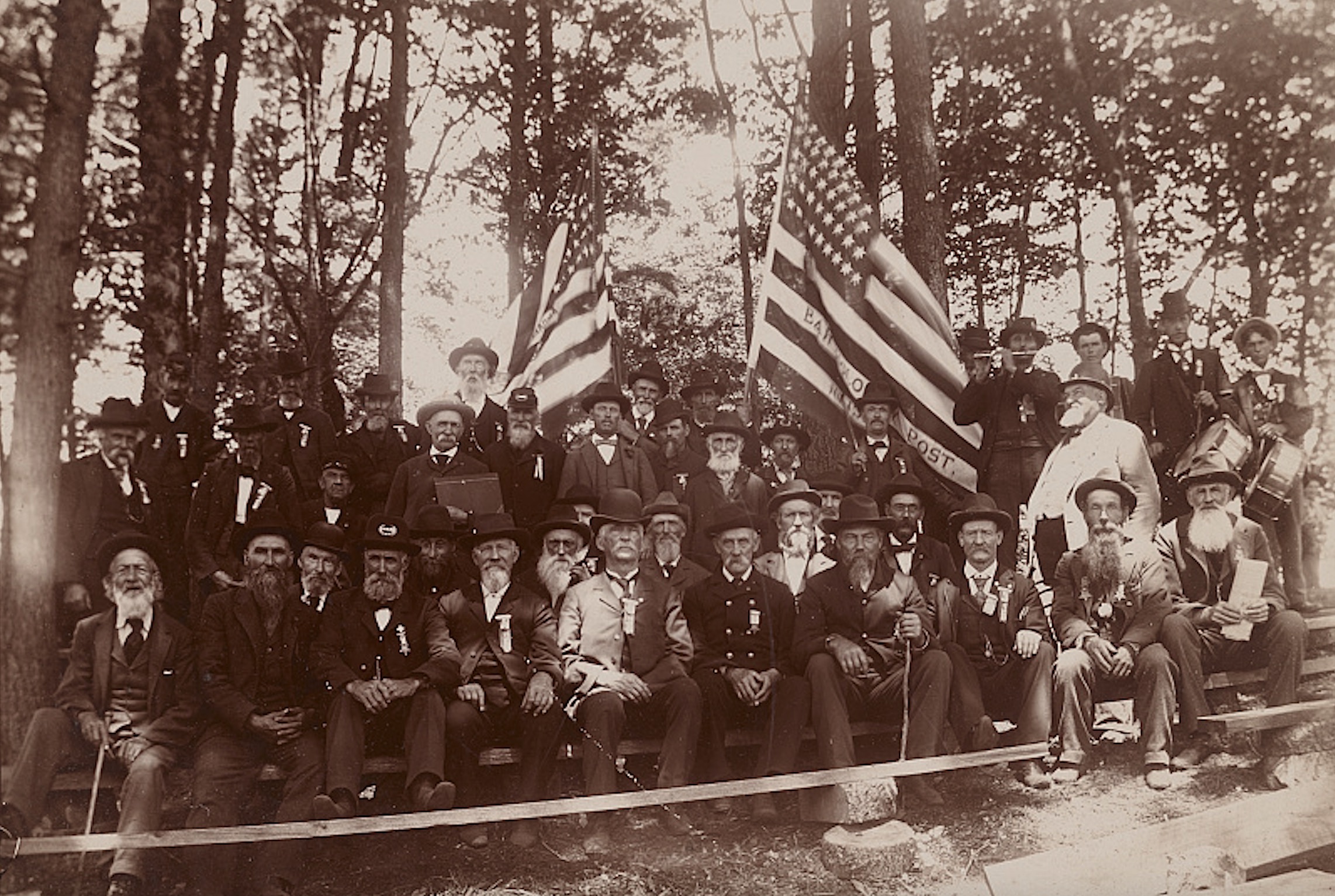 Civil War veterans of Bartholomew GAR Post #136 from Nunica, Michigan, gather sometime between 1896 and 1918. Medal of Honor recipient Henry E. Plant sits second from right in the front row.