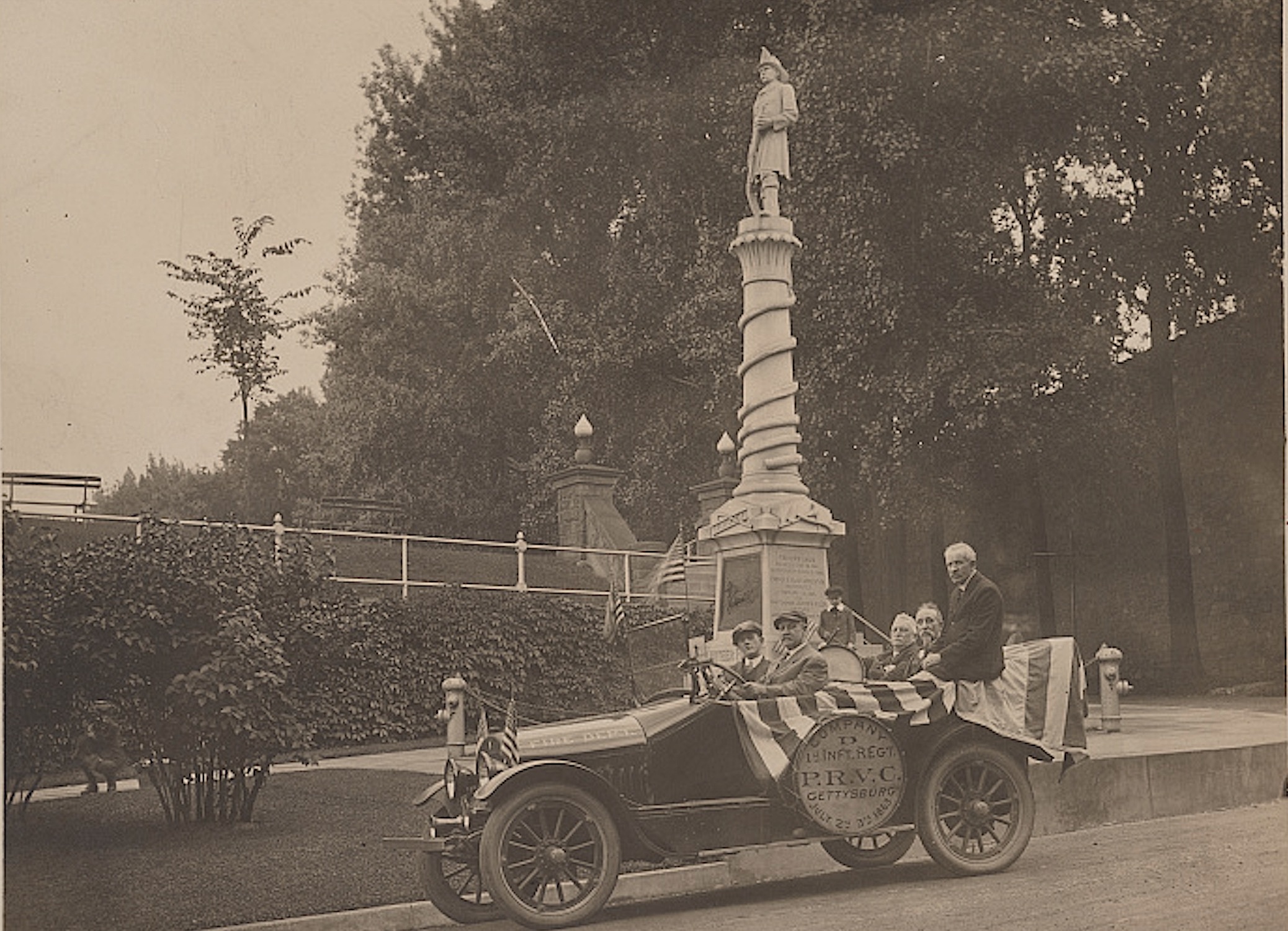 Veterans of the 30th Pennsylvania Infantry are shown in a truck in front of the Volunteer Firemen's Monument in Reading, Pennsylvania in the 1910s. 