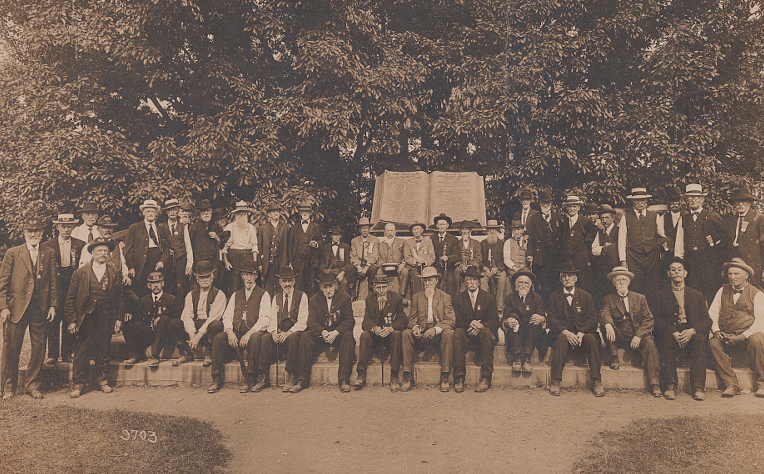 A group portrait of Union (GAR) and Confederate (UCV) veterans wearing badges and medals at the commemoration of the 50th anniversary of the Battle of Gettysburg, July 1-3, 1913.