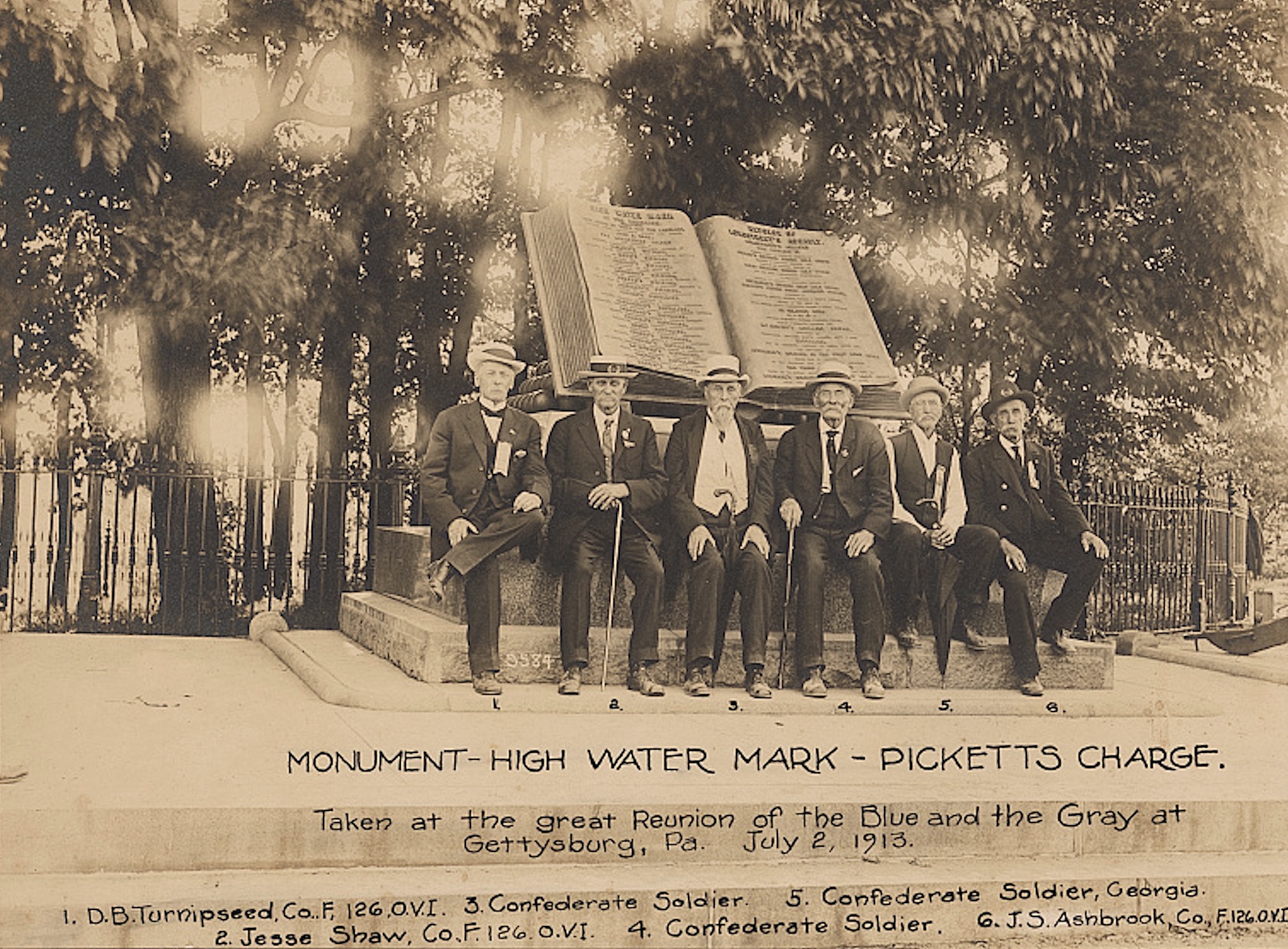 A group of Union and Confederate veterans gather in front of a monument marking the “high water mark” of Pickett’s Charge on the Gettysburg battlefield, July 2, 1913.
