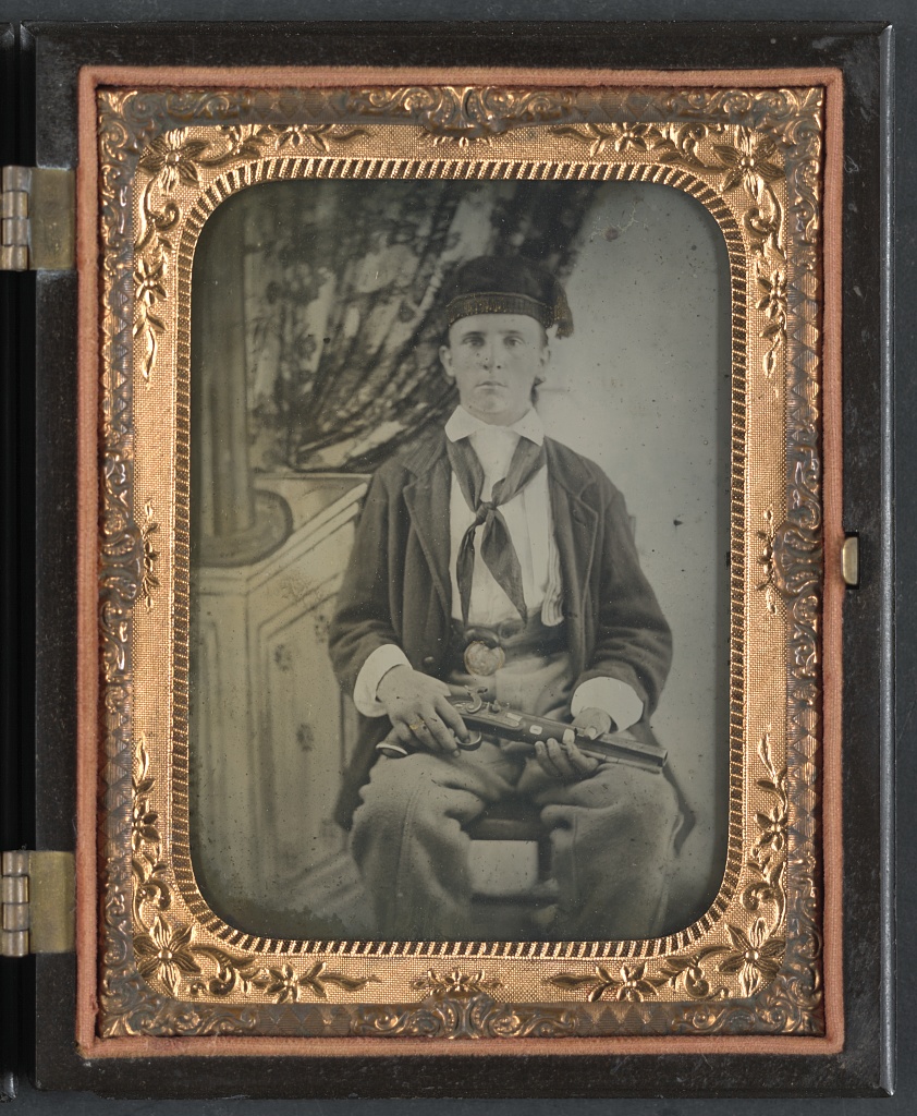 Unidentified soldier in Confederate uniform with single shot percussion pistol