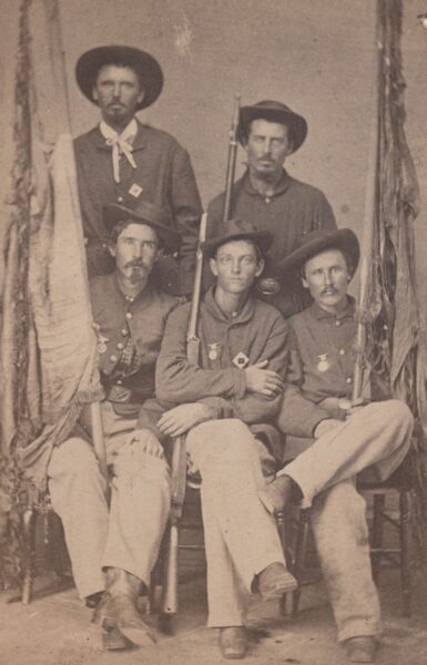 Members of the 30th Ohio Infantry's color guard pose with their tattered banners.