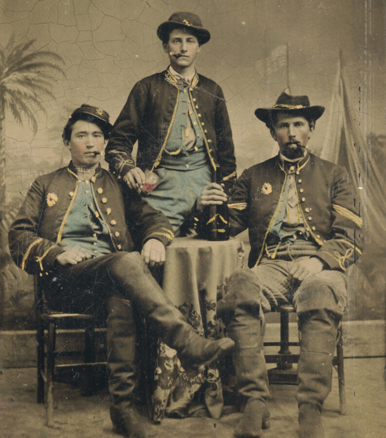 Union soldiers, cigars in their mouths, strike a refined pose for the camera.