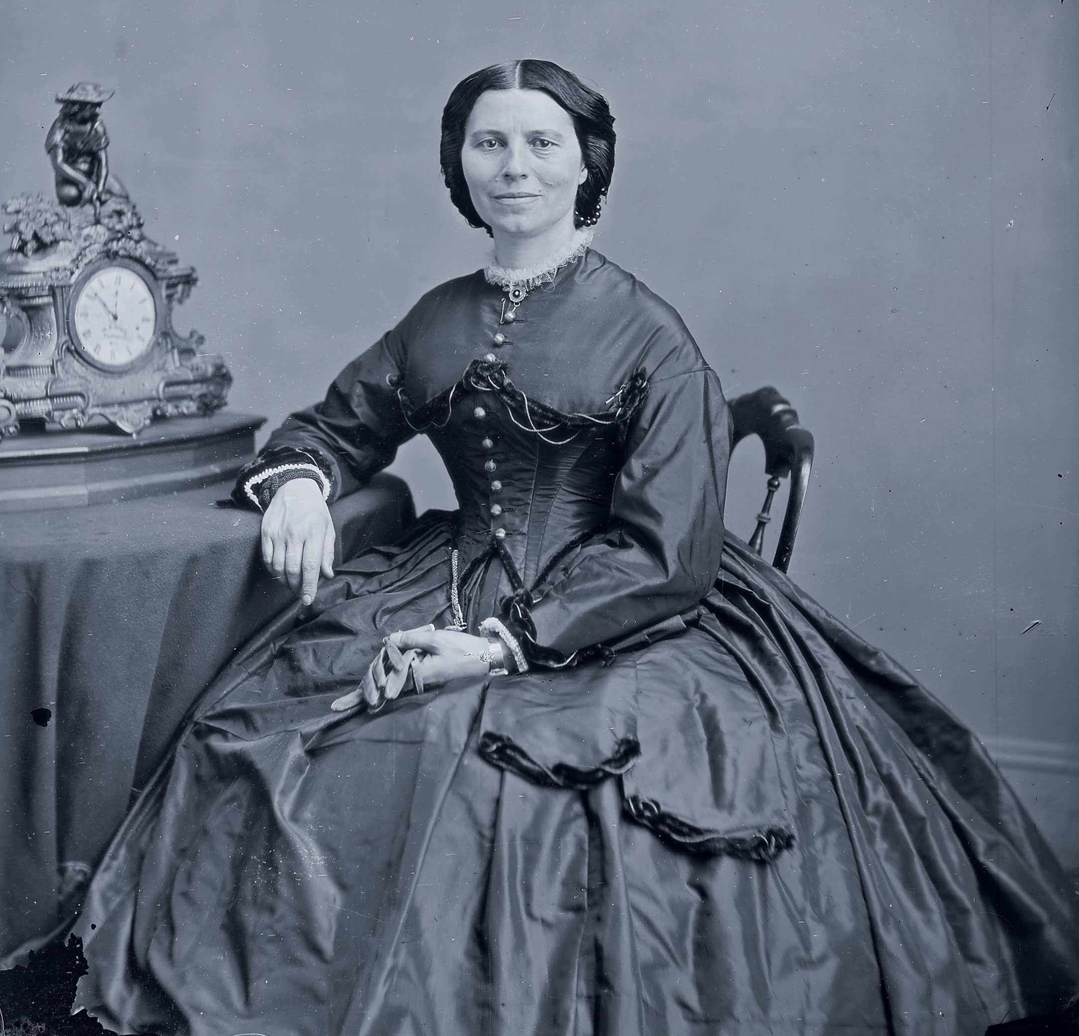 Clara Barton sitting at a table