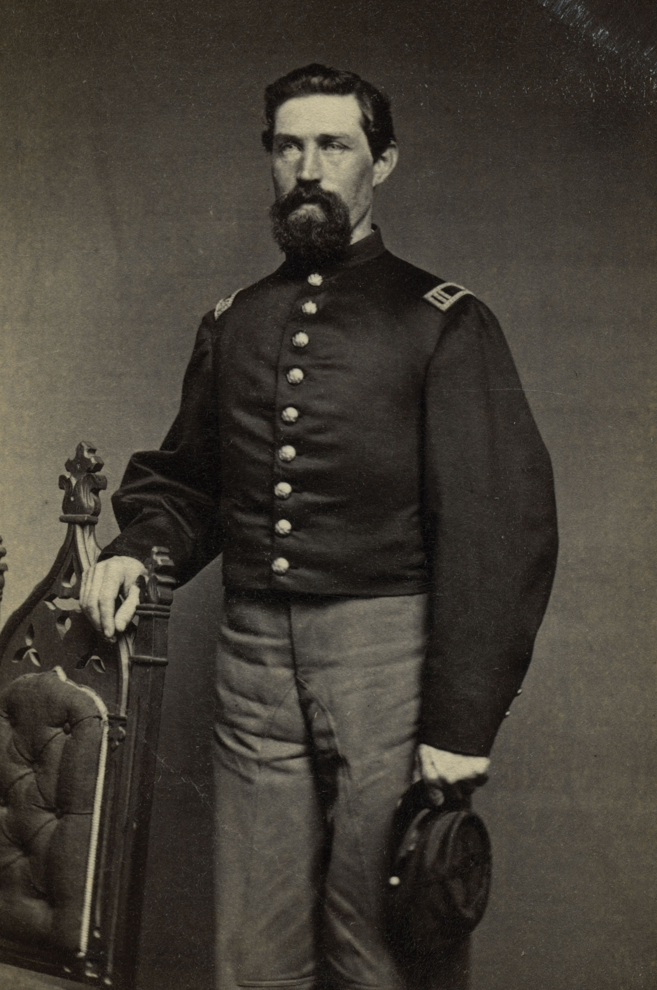 Portrait of James Bryant, Captain, 5th New York Cavalry, standing in uniform.