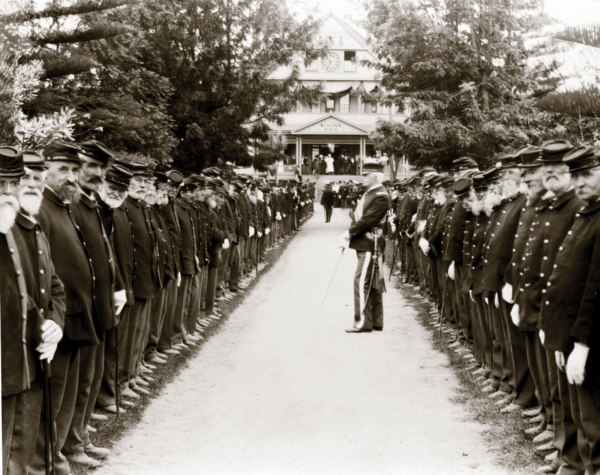 A long line of elderly Union veterans in uniform assembled for a Memorial Day review at the Santa Monica Soldiers' Home, circa 1905.