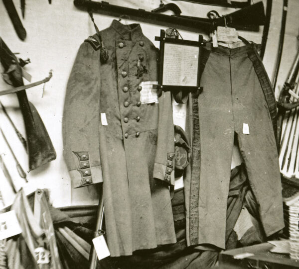 Elmer Ellsworth's blood-spattered uniform jacket and pants displayed alongside other relics at the Metropolitan Fair's Arms and Trophies Room