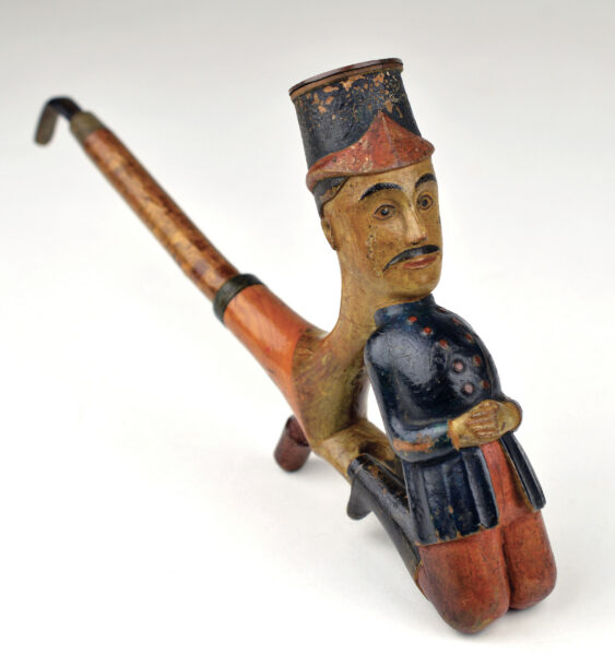 Wooden carved pipe in the shape of a kneeling man in Civil War military uniform.